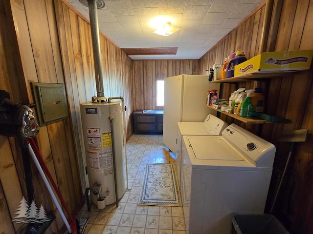 3557 Penn Rd, Lewiston, MI 49756 - laundry room with gas water heater, light flooring, independent washer and dryer, wooden walls, and electric panel