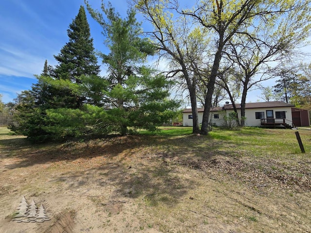 3557 Penn Rd, Lewiston, MI 49756 - view of green lawn featuring a deck