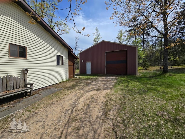3557 Penn Rd, Lewiston, MI 49756 - view of property exterior with driveway, a detached garage, and an outdoor structure
