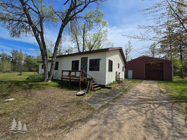 3557 Penn Rd, Lewiston, MI 49756 - manufactured / mobile home featuring driveway, a garage, and an outdoor structure