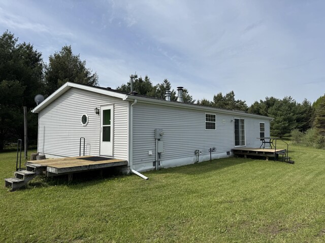 1154 M-72 W, Barton City, MI 48705 - rear view of property featuring a deck and a lawn