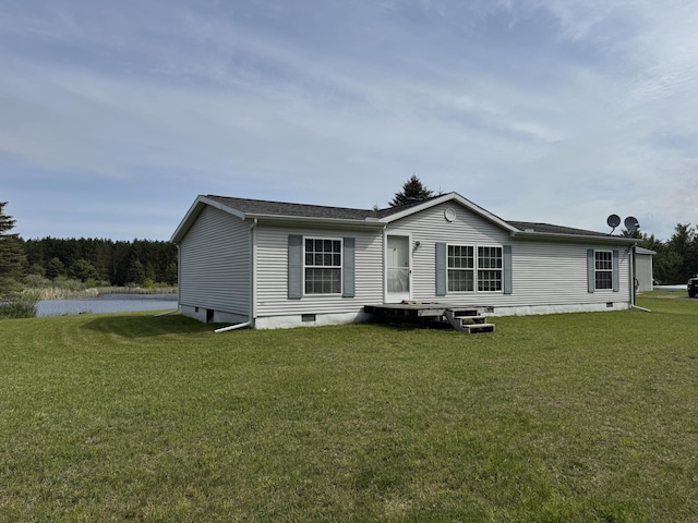 1154 M-72 W, Barton City, MI 48705 - back of property with crawl space, a yard, a water view, and roof with shingles