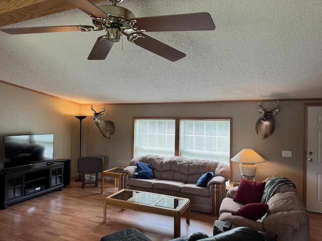 1154 M-72 W, Barton City, MI 48705 - living area featuring a textured ceiling, a ceiling fan, ornamental molding, and wood finished floors