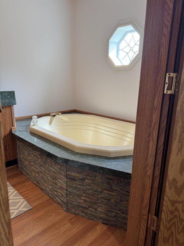 1154 M-72 W, Barton City, MI 48705 - full bath featuring a bath and wood finished floors