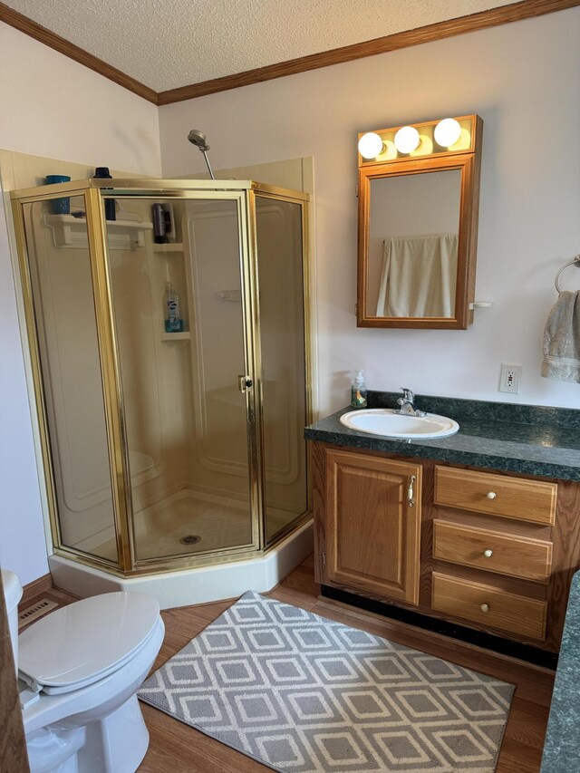 1154 M-72 W, Barton City, MI 48705 - full bathroom featuring a stall shower, vanity, ornamental molding, wood finished floors, and a textured ceiling