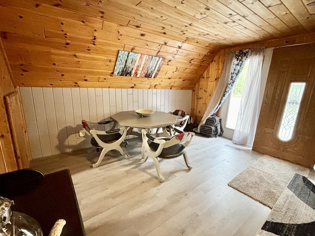 3334 Pleasant View Dr, Lewiston, MI 49756 - dining space featuring wooden ceiling, wood walls, lofted ceiling, and wood finished floors