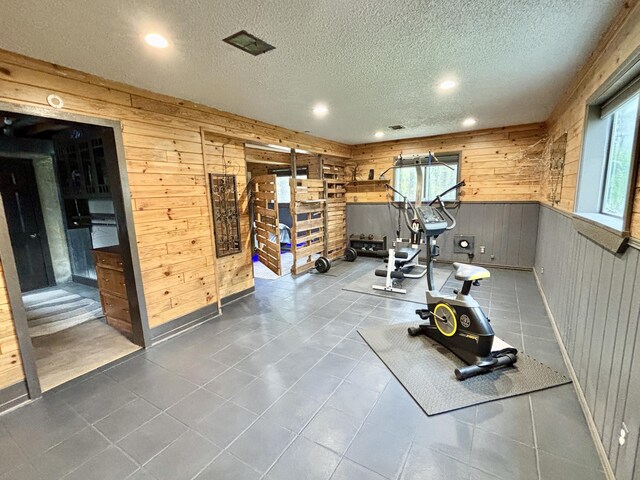3334 Pleasant View Dr, Lewiston, MI 49756 - workout area with wood walls, a textured ceiling, recessed lighting, and tile patterned floors