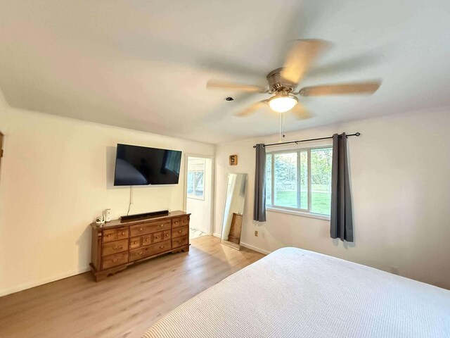 116 1st St, Hubbard Lake, MI 49747 - bedroom with wood finished floors, ceiling fan, and baseboards