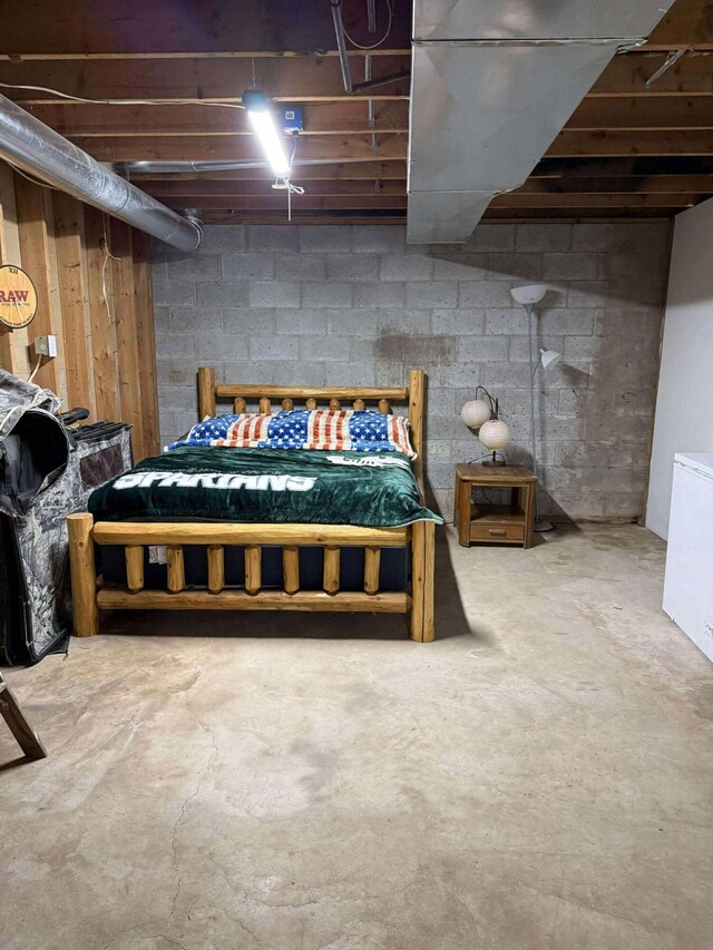 116 1st St, Hubbard Lake, MI 49747 - bedroom featuring concrete floors