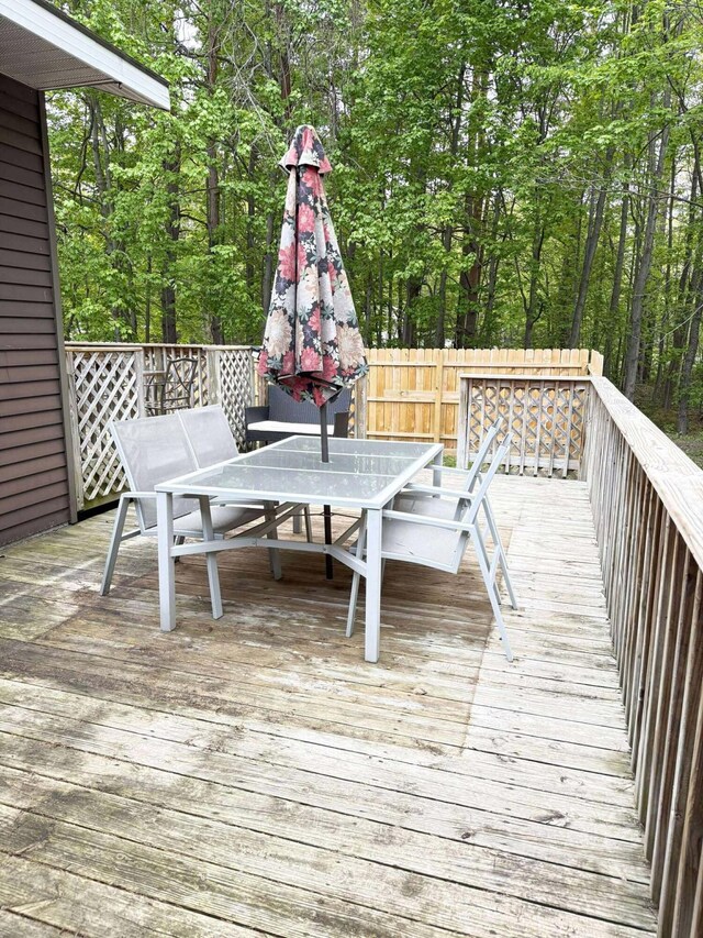 116 1st St, Hubbard Lake, MI 49747 - wooden deck with outdoor dining area