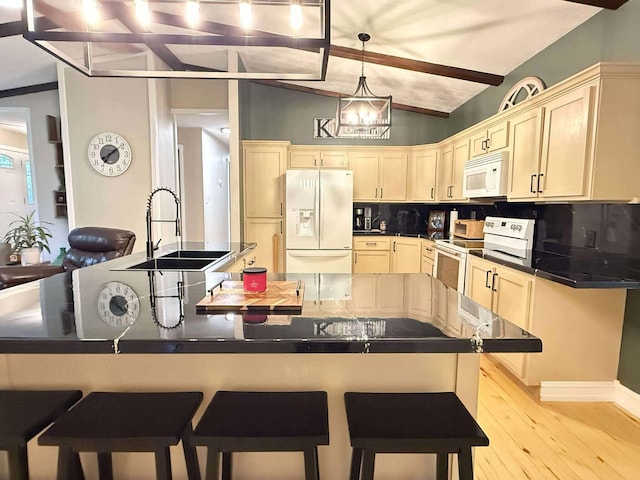 116 1st St, Hubbard Lake, MI 49747 - kitchen with white appliances, a sink, backsplash, light wood-style floors, and a breakfast bar area
