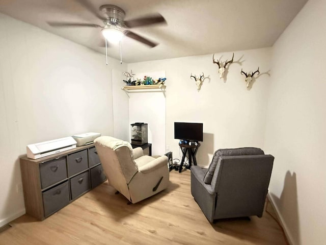 116 1st St, Hubbard Lake, MI 49747 - sitting room with a ceiling fan, light wood finished floors, and baseboards
