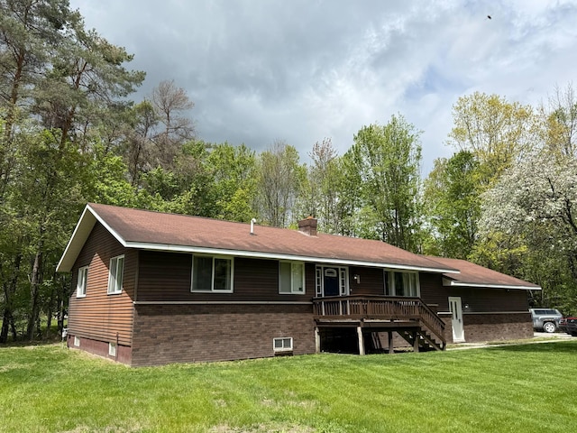 116 1st St, Hubbard Lake, MI 49747 - rear view of property with a yard, a chimney, and brick siding