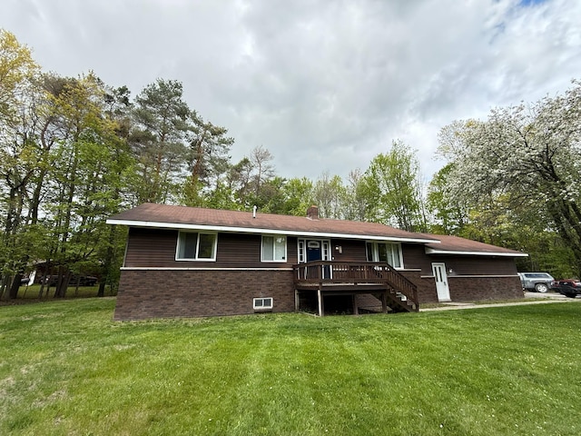 116 1st St, Hubbard Lake, MI 49747 - rear view of property featuring a yard, brick siding, and a chimney