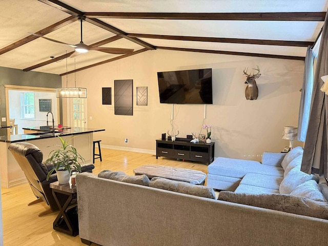 116 1st St, Hubbard Lake, MI 49747 - living room featuring light wood finished floors, baseboards, and a ceiling fan