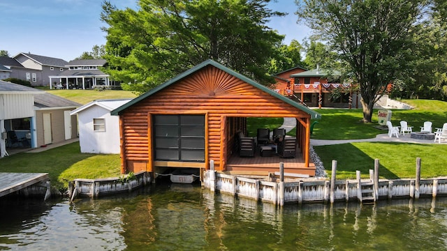 5997 Prospect St, Indian River, MI 49749 - dock featuring a fire pit, a deck with water view, and a lawn