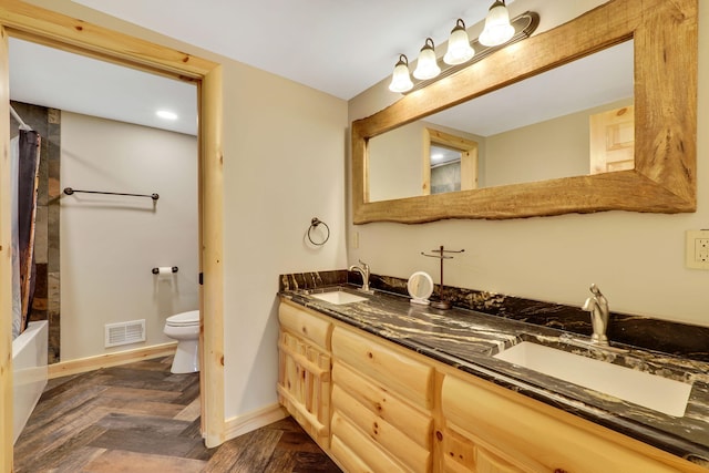 5997 Prospect St, Indian River, MI 49749 - bathroom featuring toilet, double vanity, baseboards, and shower / bath combination with curtain