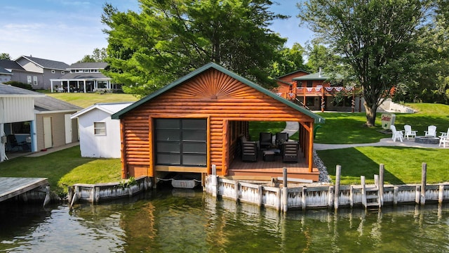 5997 Prospect St, Indian River, MI 49749 - dock with a fire pit, a deck with water view, and a lawn