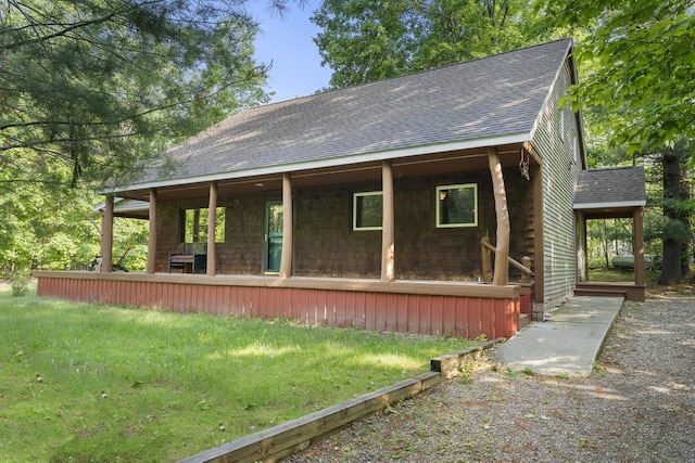 2715 Indian Rd, Brutus, MI 49716 - view of front facade featuring a shingled roof and a porch