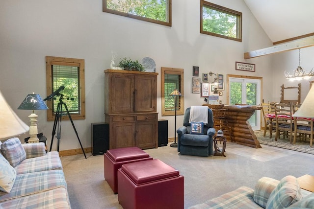 2715 Indian Rd, Brutus, MI 49716 - living room featuring high vaulted ceiling, light colored carpet, and a chandelier
