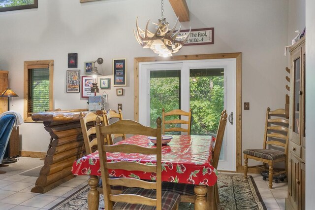 2715 Indian Rd, Brutus, MI 49716 - dining room with light tile patterned floors, a chandelier, a bar, a high ceiling, and beamed ceiling