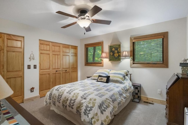 2715 Indian Rd, Brutus, MI 49716 - bedroom with a closet, light colored carpet, and ceiling fan