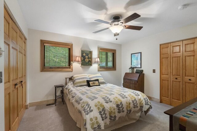 2715 Indian Rd, Brutus, MI 49716 - bedroom with light carpet and ceiling fan
