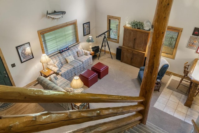 2715 Indian Rd, Brutus, MI 49716 - carpeted living room featuring baseboards and tile patterned flooring