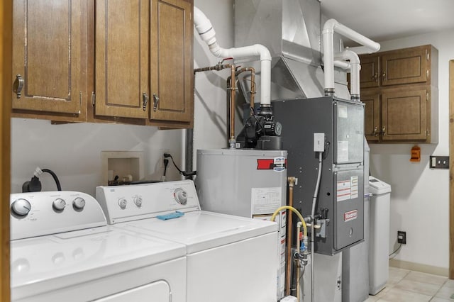2715 Indian Rd, Brutus, MI 49716 - washroom with independent washer and dryer, cabinet space, light tile patterned floors, and gas water heater
