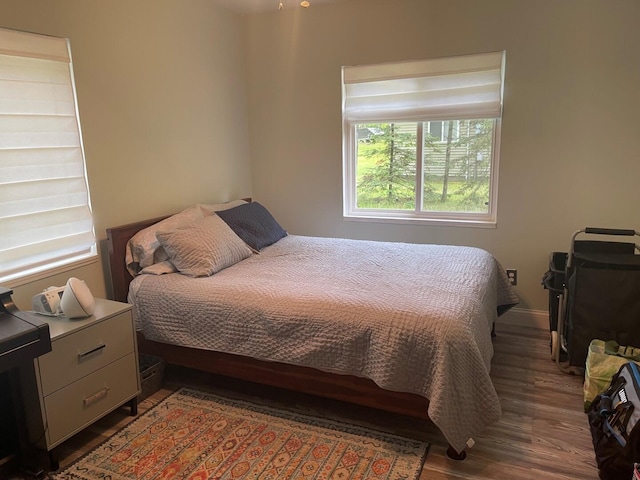 117 Swift Deer Trl, Prudenville, MI 48651 - bedroom featuring wood finished floors and baseboards