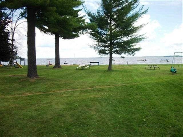 117 Swift Deer Trl, Prudenville, MI 48651 - surrounding community with a yard and a water view