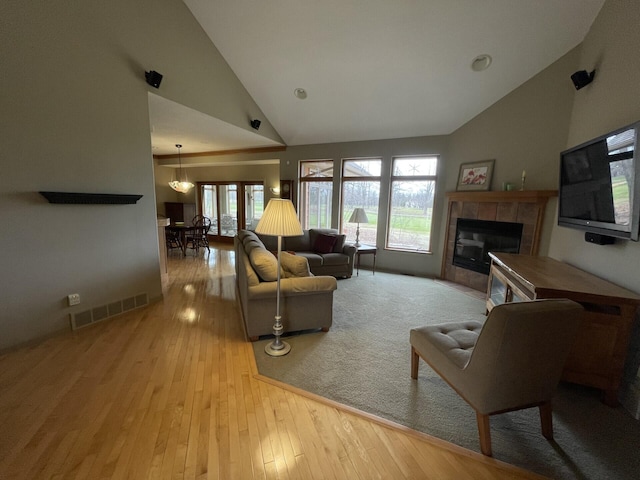 164 Invitational Dr, Gaylord, MI 49735 - living room with a tile fireplace, hardwood / wood-style floors, and high vaulted ceiling