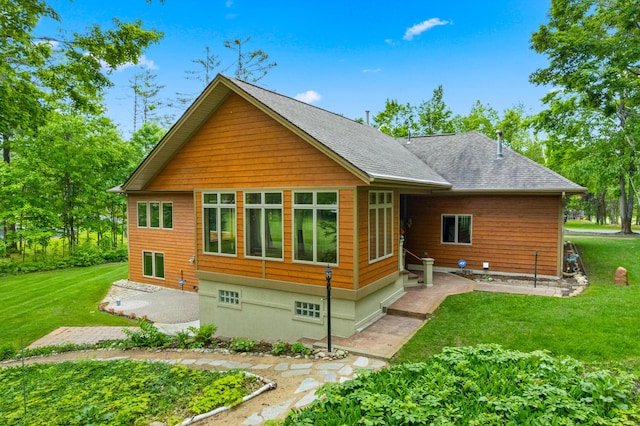 164 Invitational Dr, Gaylord, MI 49735 - rear view of house with a patio, a lawn, and a shingled roof