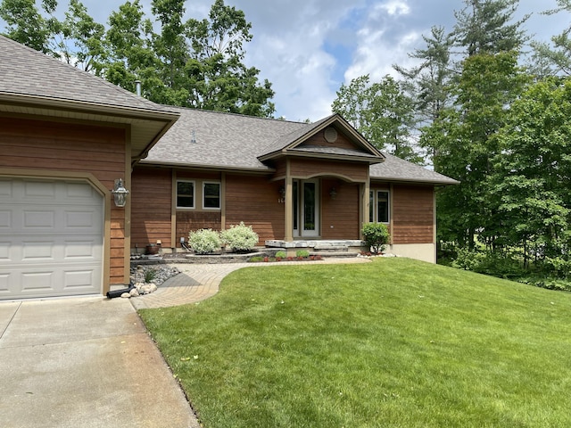 164 Invitational Dr, Gaylord, MI 49735 - view of front of property featuring concrete driveway, a front yard, a garage, and a shingled roof