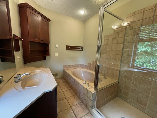 164 Invitational Dr, Gaylord, MI 49735 - full bathroom featuring a textured ceiling, a garden tub, a stall shower, vanity, and tile patterned floors