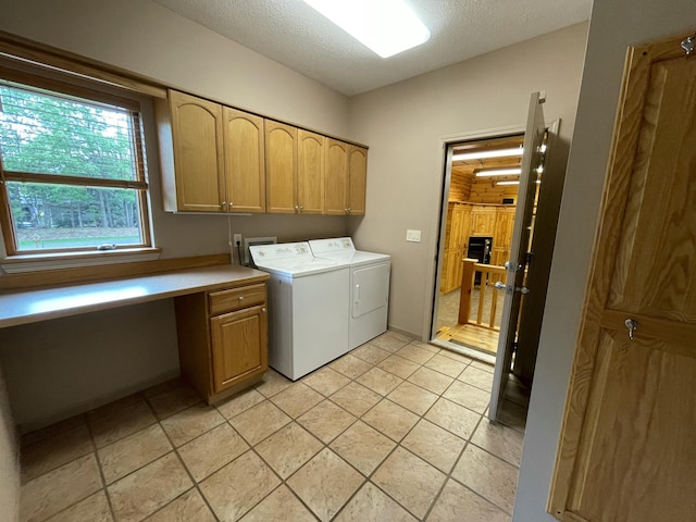 164 Invitational Dr, Gaylord, MI 49735 - washroom featuring cabinet space, separate washer and dryer, an office area, and a textured ceiling
