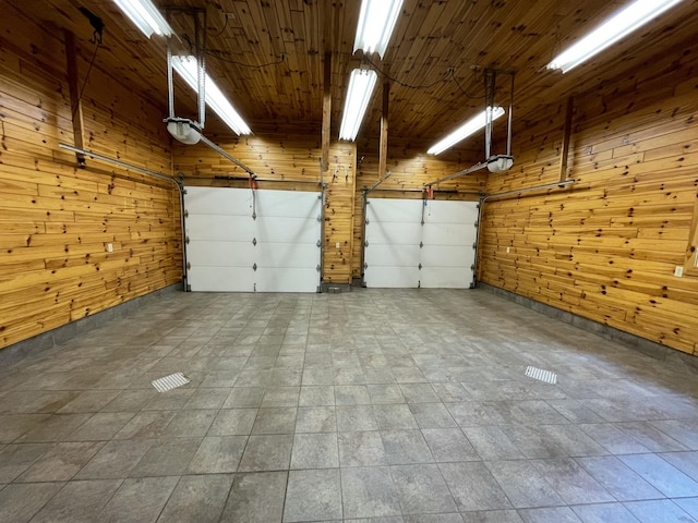 164 Invitational Dr, Gaylord, MI 49735 - garage with wood walls and a garage door opener