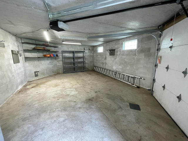 164 Invitational Dr, Gaylord, MI 49735 - garage with a garage door opener and concrete block wall