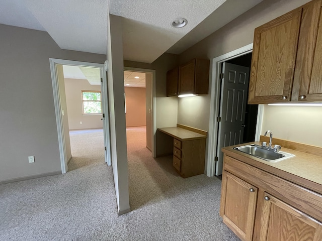 164 Invitational Dr, Gaylord, MI 49735 - kitchen featuring light colored carpet, light countertops, and a textured ceiling