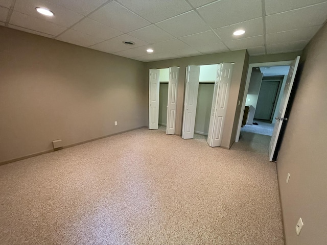 164 Invitational Dr, Gaylord, MI 49735 - unfurnished bedroom with light carpet, recessed lighting, a drop ceiling, and two closets