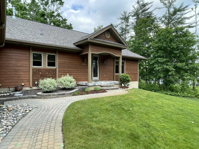 164 Invitational Dr, Gaylord, MI 49735 - view of front of property featuring a front yard and a shingled roof