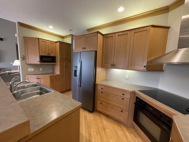 164 Invitational Dr, Gaylord, MI 49735 - kitchen featuring black appliances, wall chimney range hood, crown molding, light wood-style floors, and recessed lighting