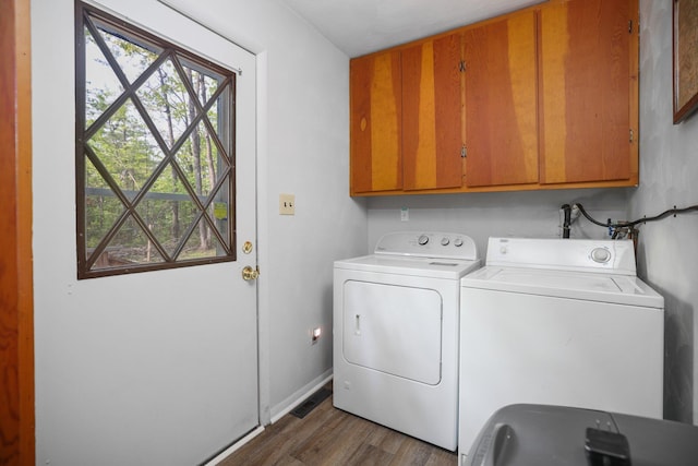 2040 Mary Anne Dr, Lewiston, MI 49756 - laundry room featuring cabinet space, washer and clothes dryer, wood finished floors, and baseboards