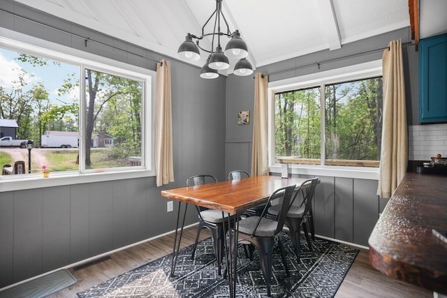 2040 Mary Anne Dr, Lewiston, MI 49756 - dining room featuring wood finished floors and a chandelier