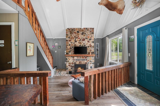 2040 Mary Anne Dr, Lewiston, MI 49756 - foyer entrance with beamed ceiling, stairway, a stone fireplace, wood finished floors, and high vaulted ceiling