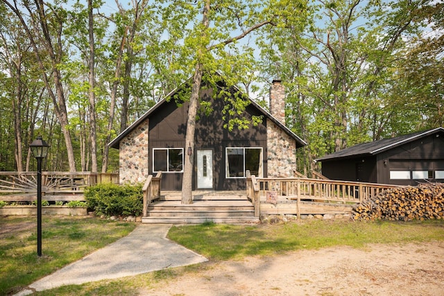 2040 Mary Anne Dr, Lewiston, MI 49756 - view of front of house with a chimney and a deck