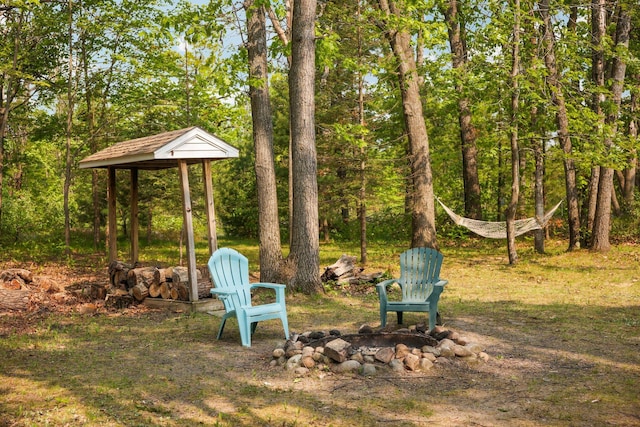 2040 Mary Anne Dr, Lewiston, MI 49756 - view of yard featuring an outdoor fire pit