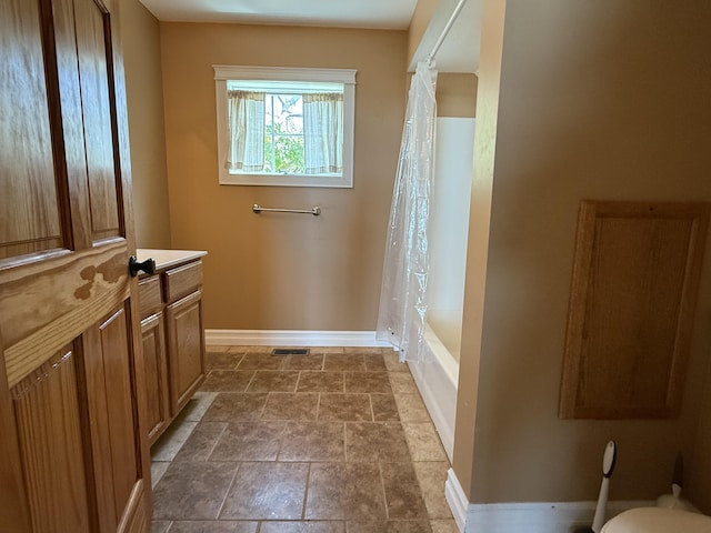 13551 US-23, Cheboygan, MI 49721 - full bath with stone finish floors, shower / tub combo, and vanity