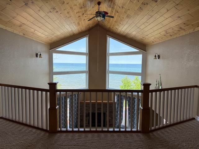 13551 US-23, Cheboygan, MI 49721 - hall featuring a textured wall, a water view, carpet flooring, vaulted ceiling, and wood ceiling
