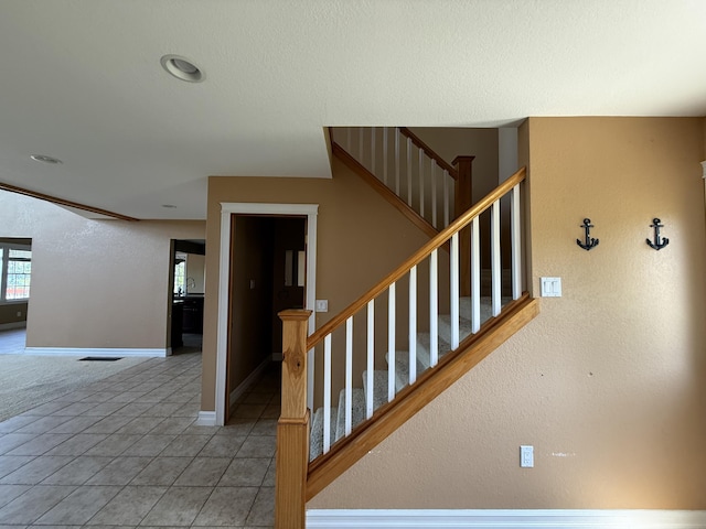 13551 US-23, Cheboygan, MI 49721 - stairway with baseboards and tile patterned floors